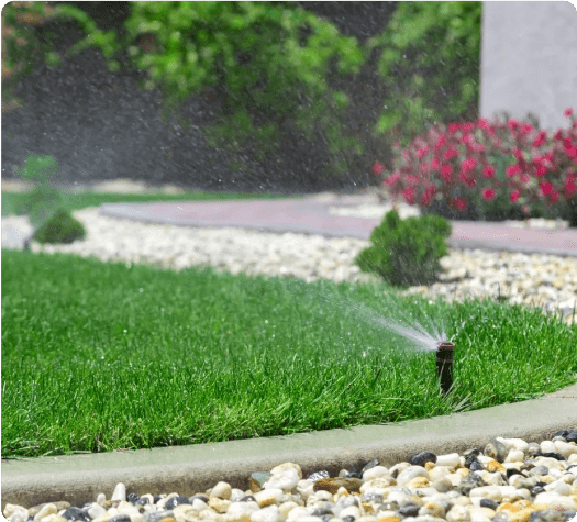 A garden with grass and water sprinklers.